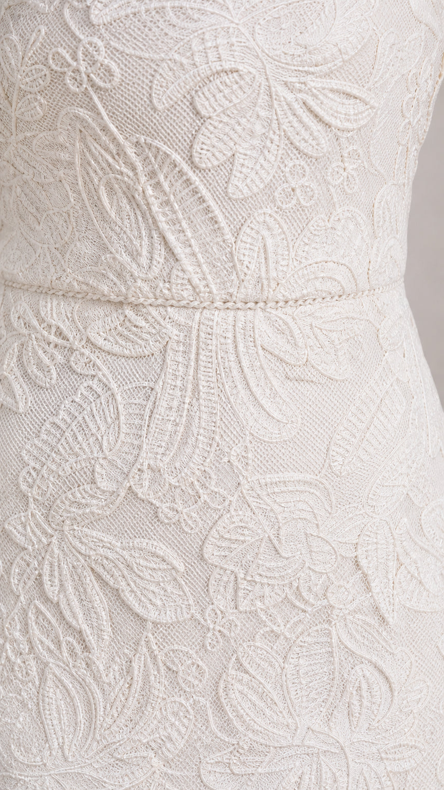 Close-up detail of White floral lace and waist trim