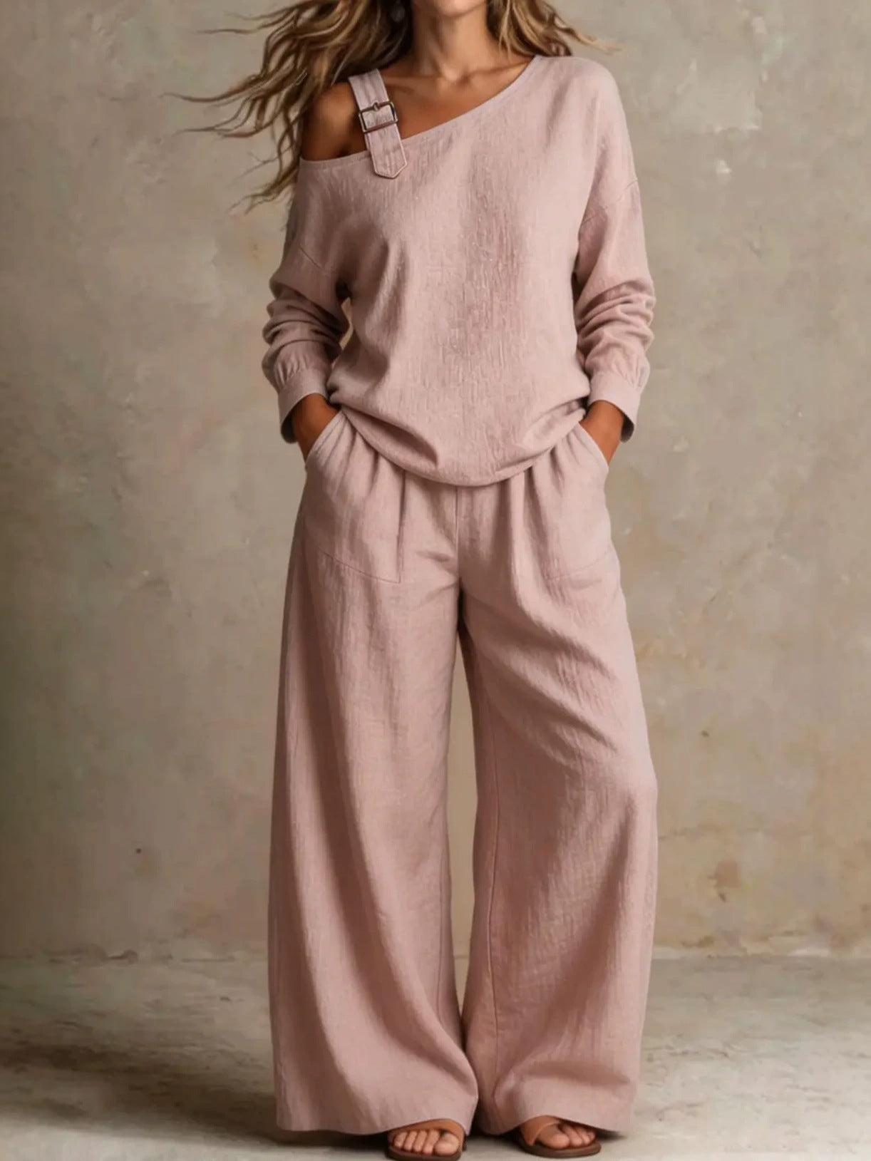 Woman wearing pink asymmetric buckle top and wide-leg pants lounge set