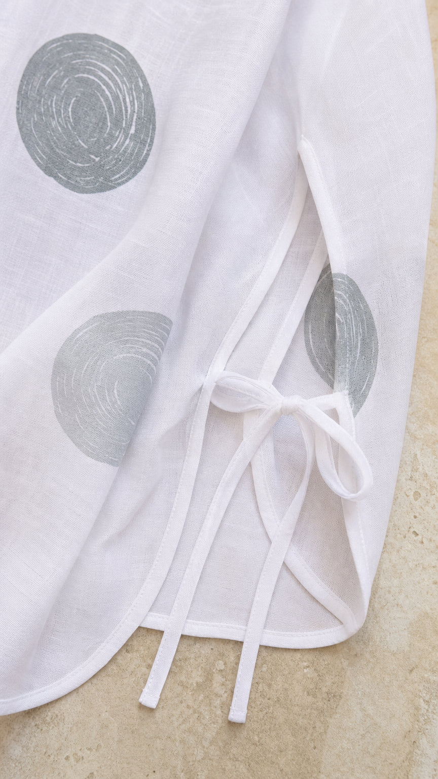 Close-up of tunic hem and split sleeve with tie bow detail