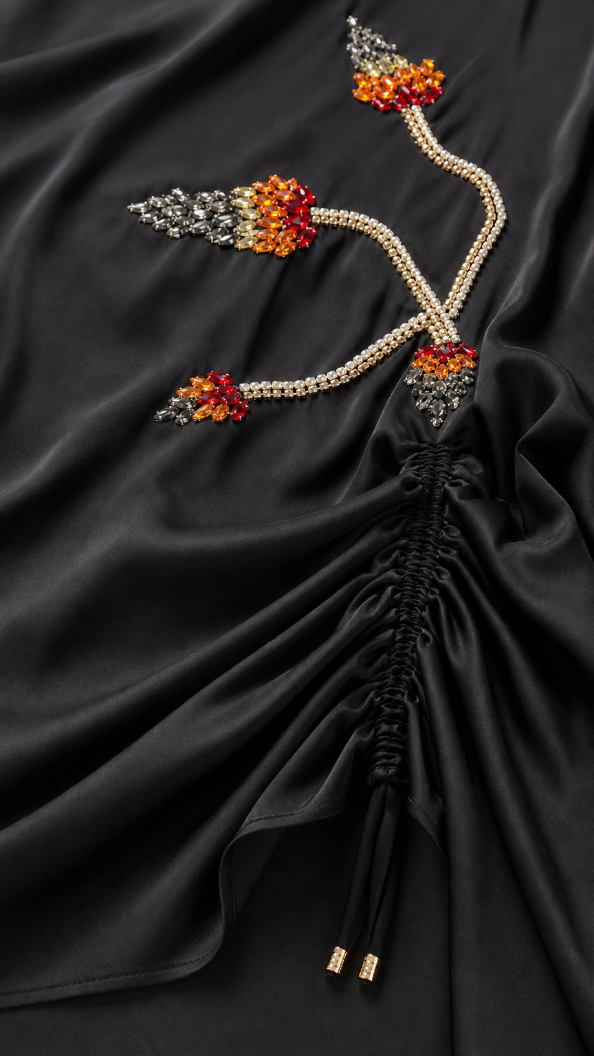 Close-up of intricate beadwork and ruched drawstring detail
