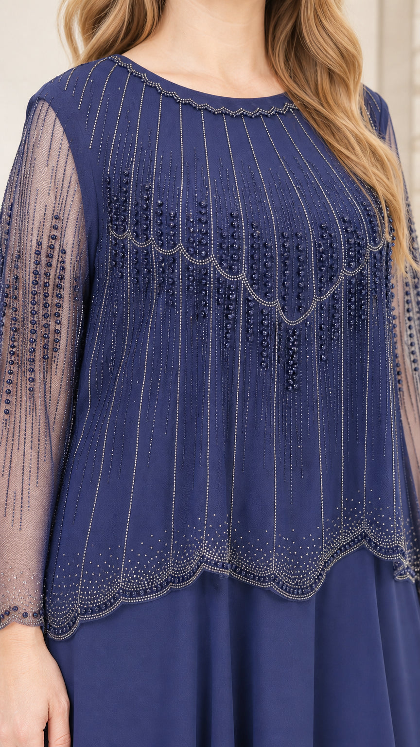 Close-up detail of beaded bodice and sheer sleeves on navy dress
