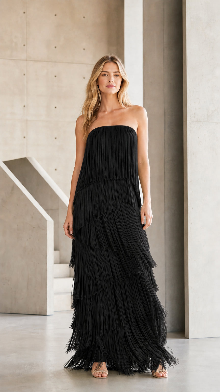 Front view of black tiered fringe strapless maxi dress