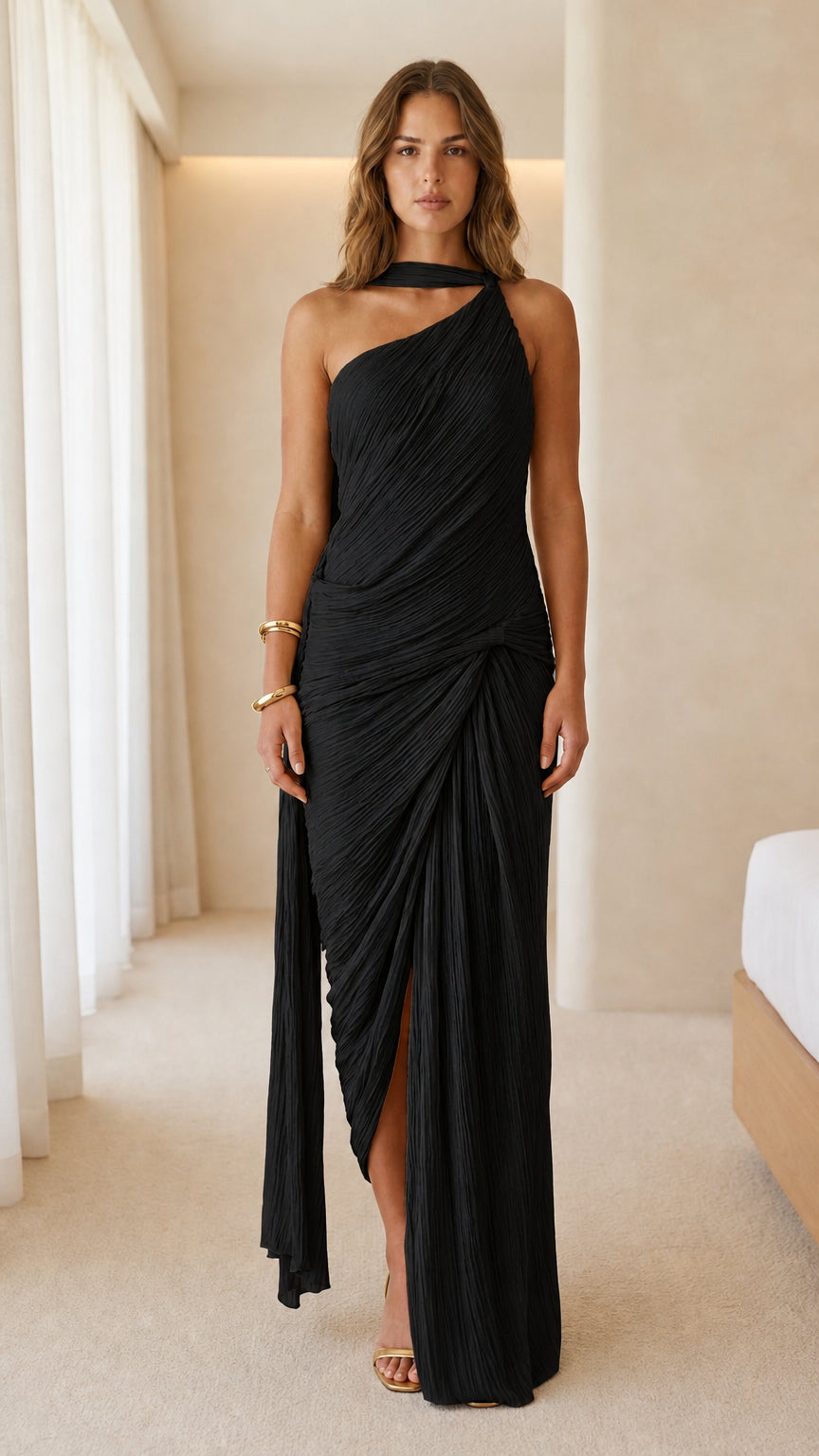 Front view of woman wearing black one-shoulder pleated maxi dress