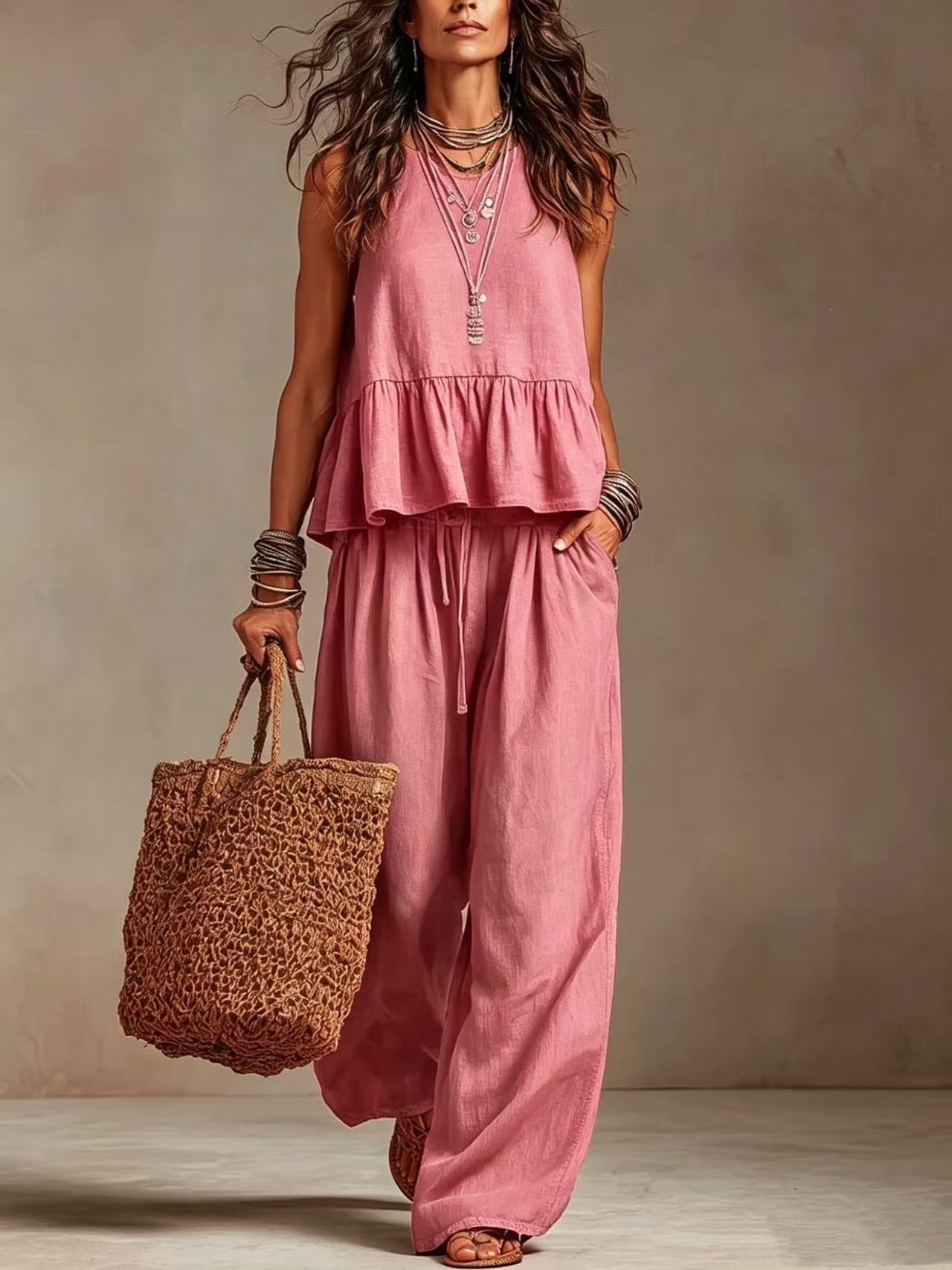 Woman wearing pink boho sleeveless peplum top and wide leg pants set