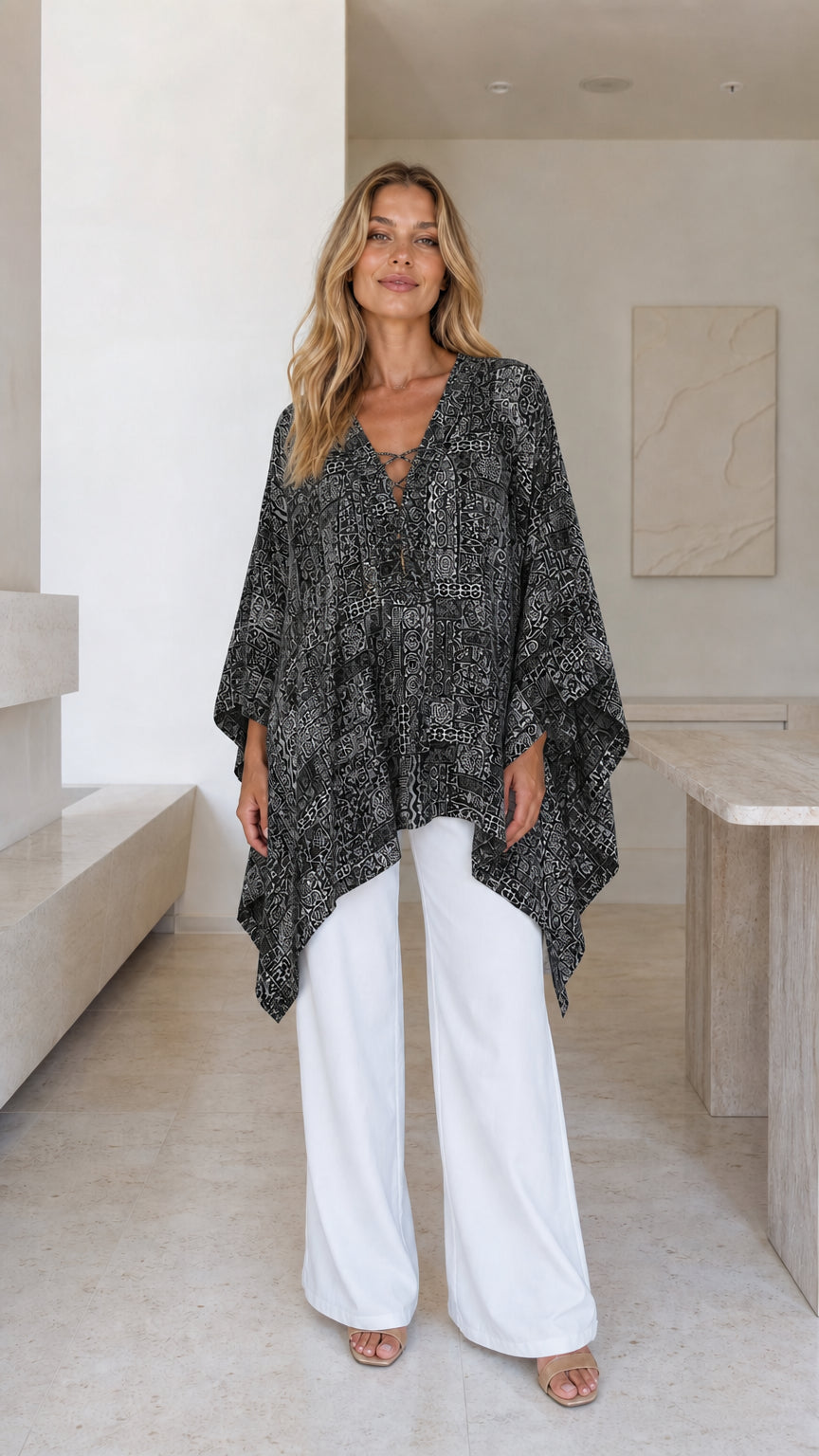 Model wearing black printed boho poncho top