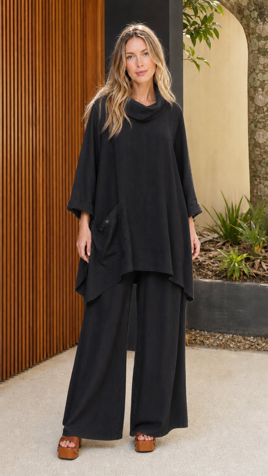 Model wearing black cowl neck tunic and wide leg pants set