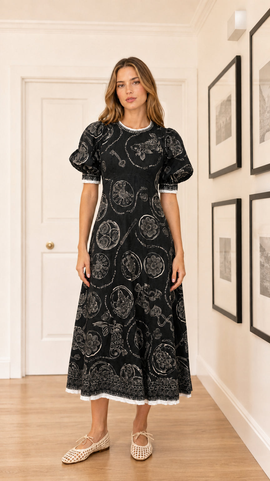 Woman wearing black embroidered puff sleeve midi dress