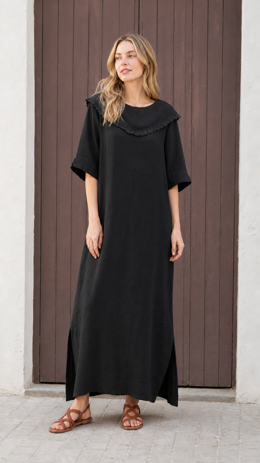 Front view of woman wearing black relaxed-fit maxi dress