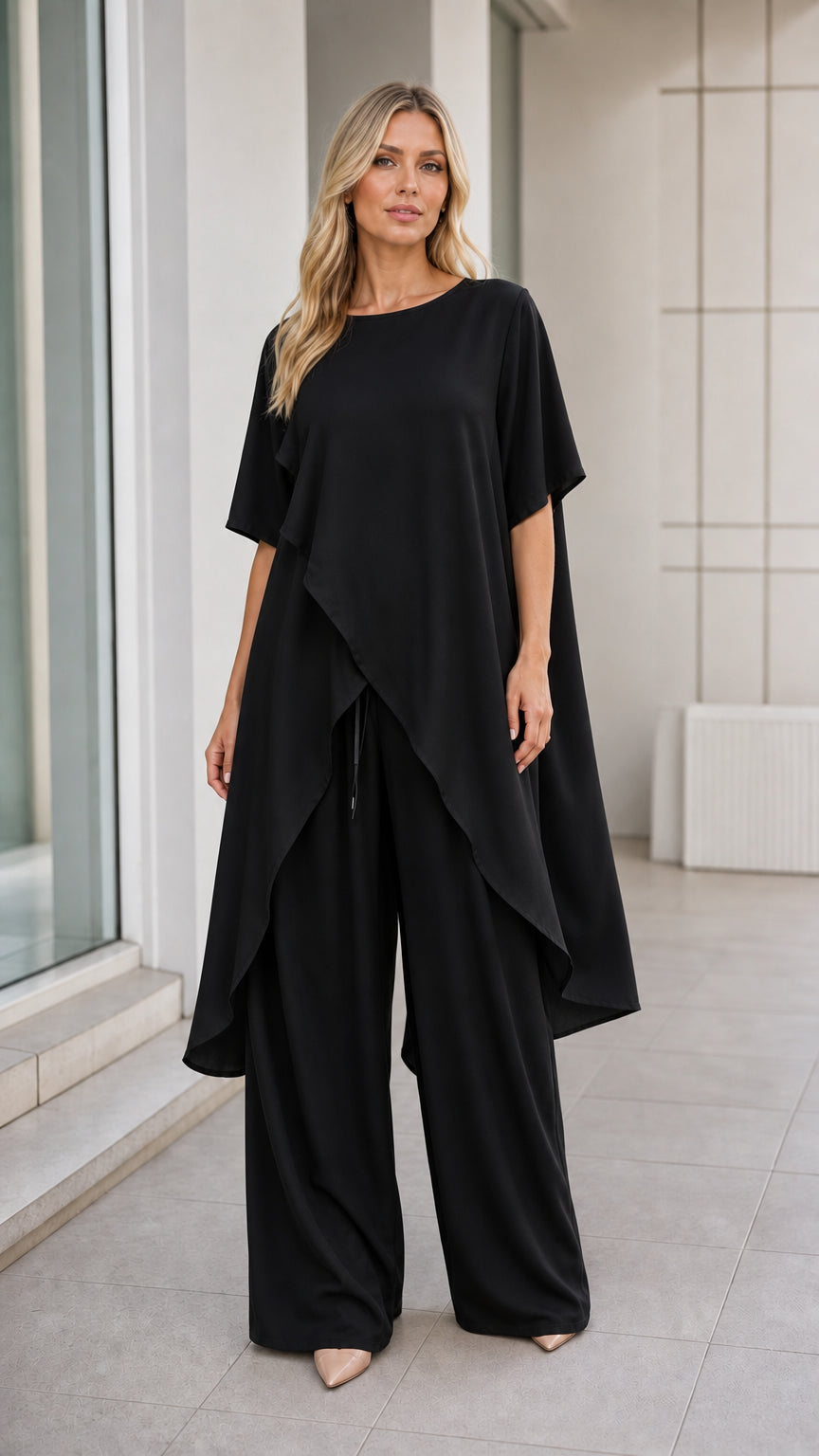 Model wearing black asymmetric tunic and wide-leg pants set