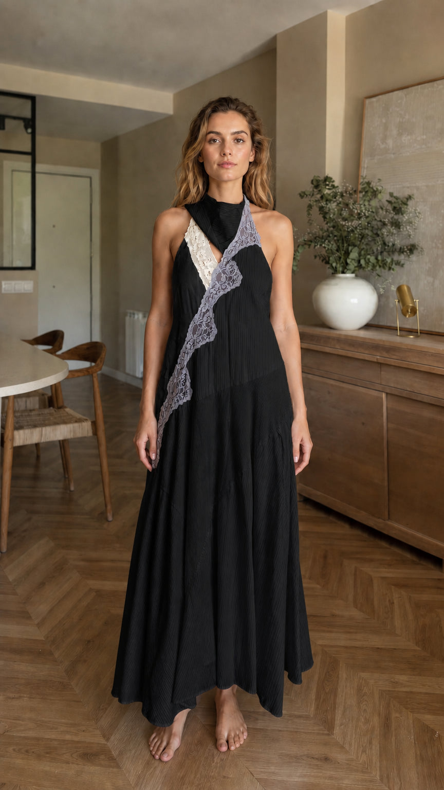 Front view of woman wearing black halter maxi dress