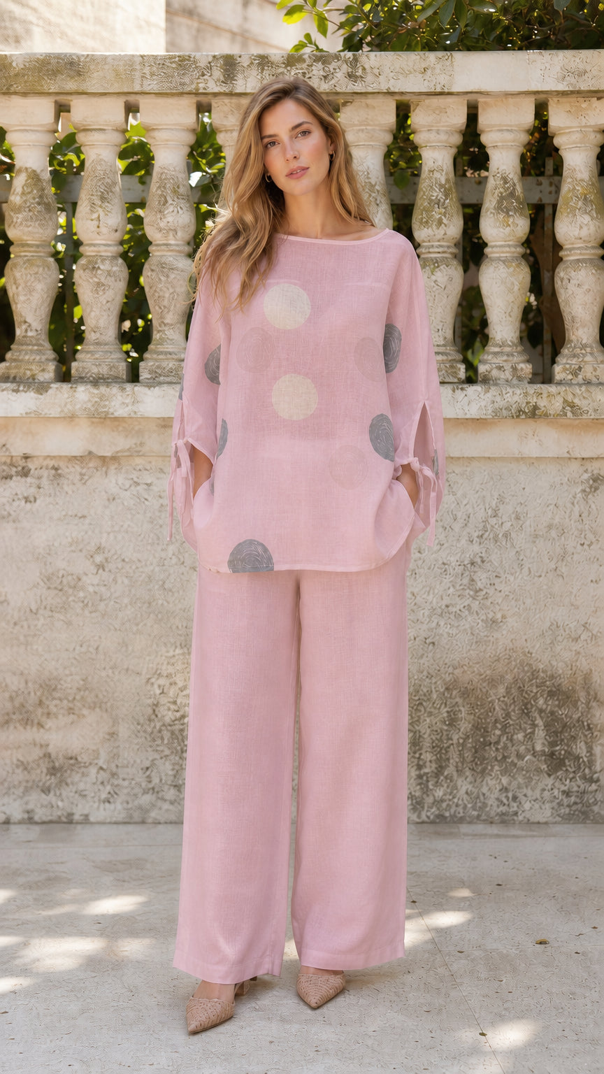 Front view of woman wearing pink polka dot two-piece set