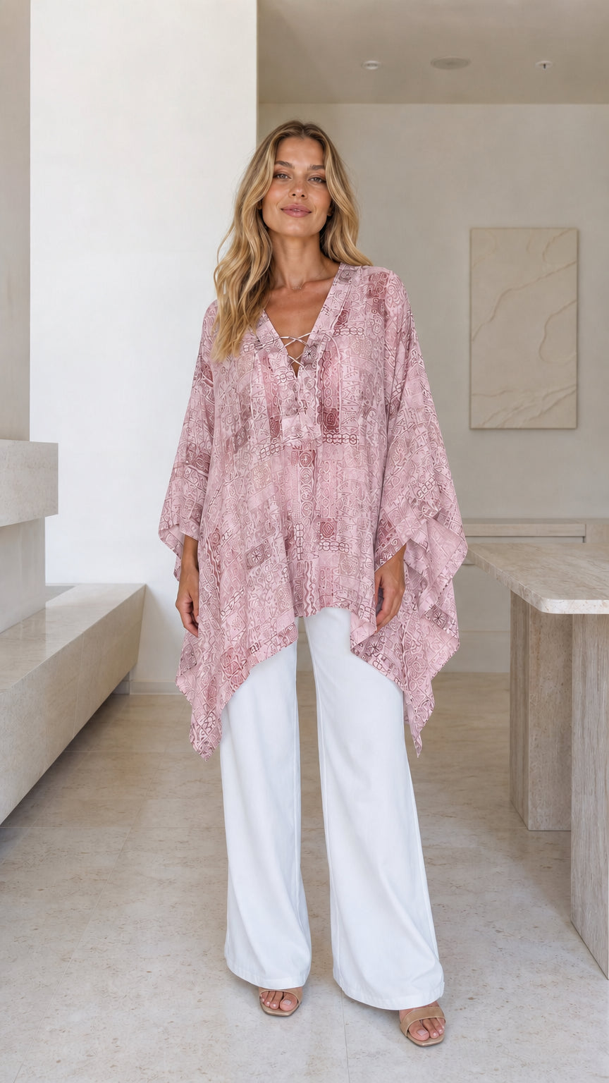 Model wearing pink printed boho poncho top