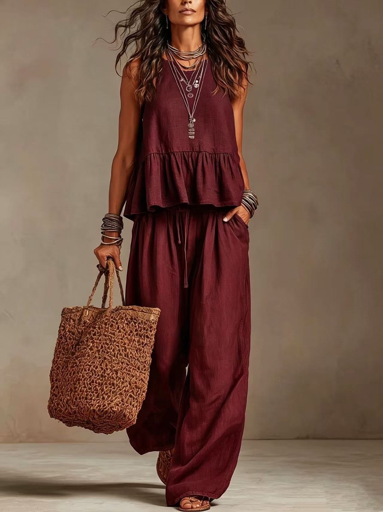 Woman wearing burgundy boho sleeveless peplum top and wide leg pants set