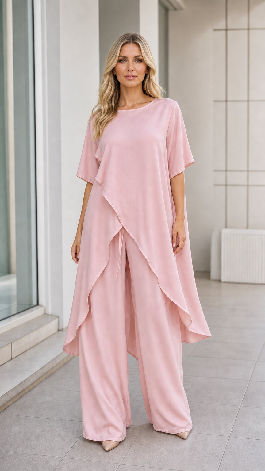 Model wearing pink asymmetric tunic and wide-leg pants set