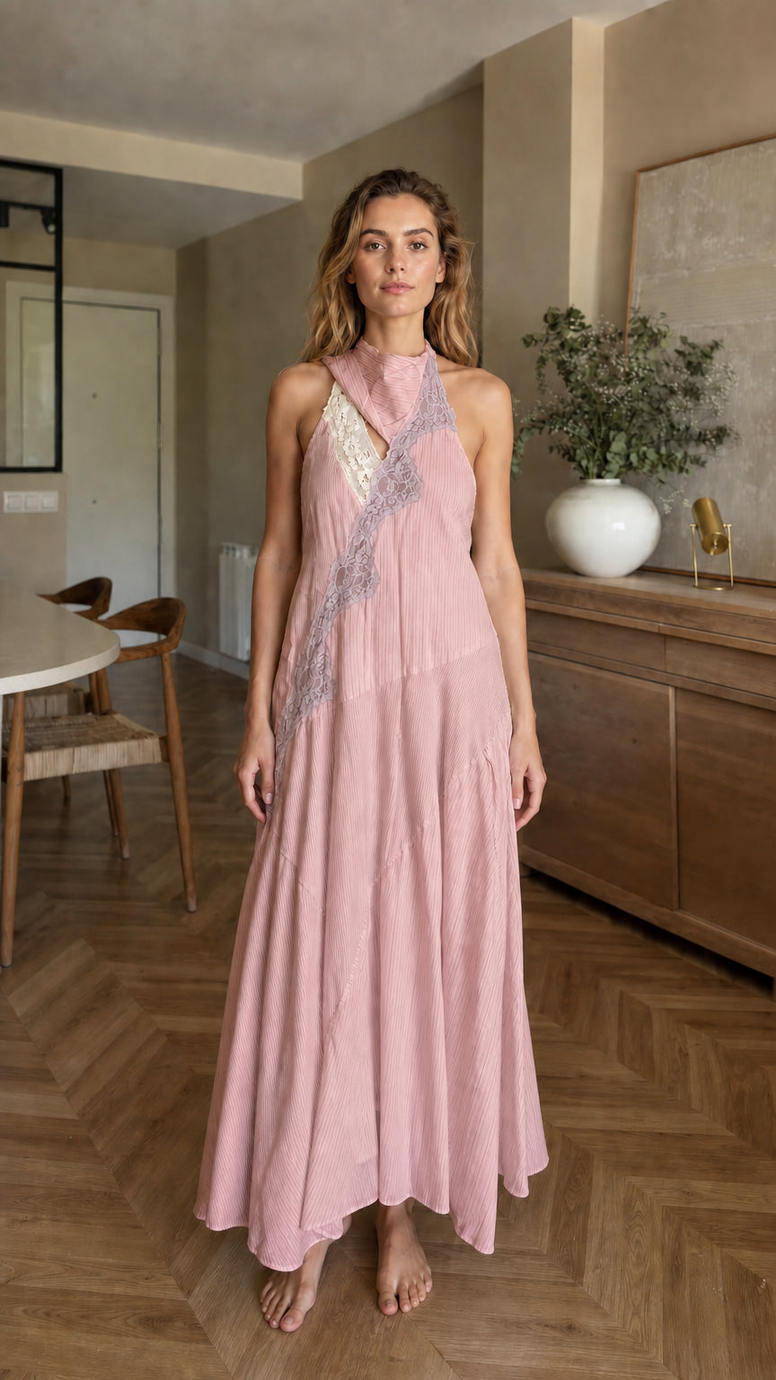 Front view of woman wearing pink halter maxi dress
