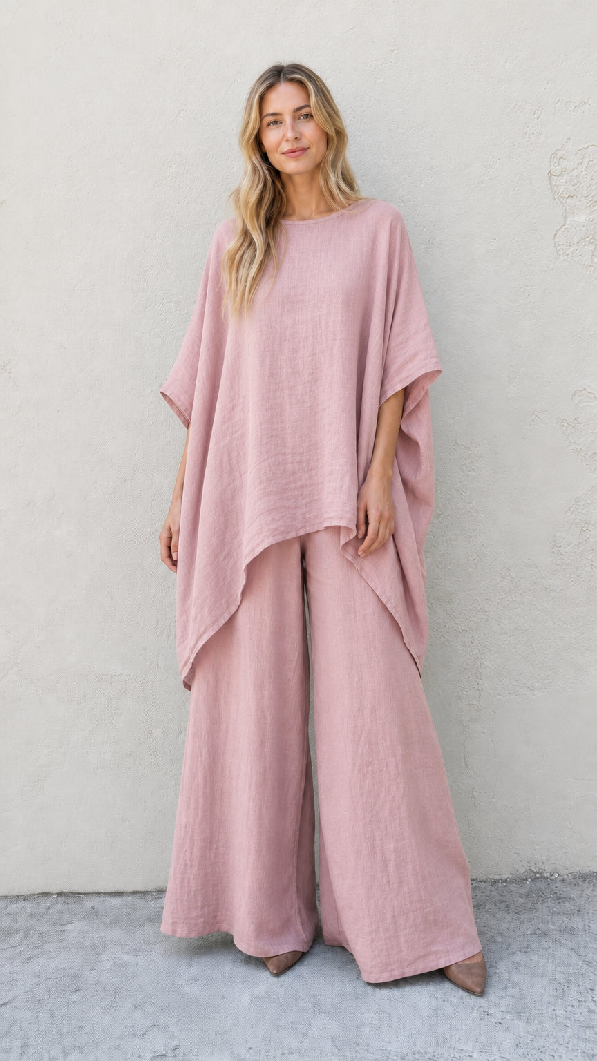 Woman wearing pink two-piece poncho and wide leg pants set
