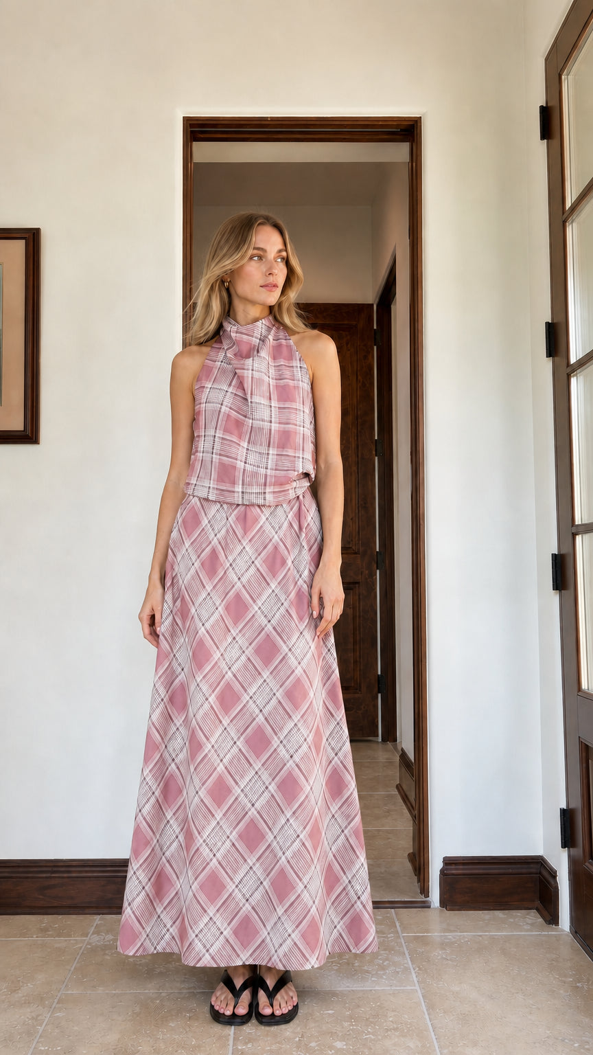 Woman wearing pink plaid halter top and matching maxi skirt