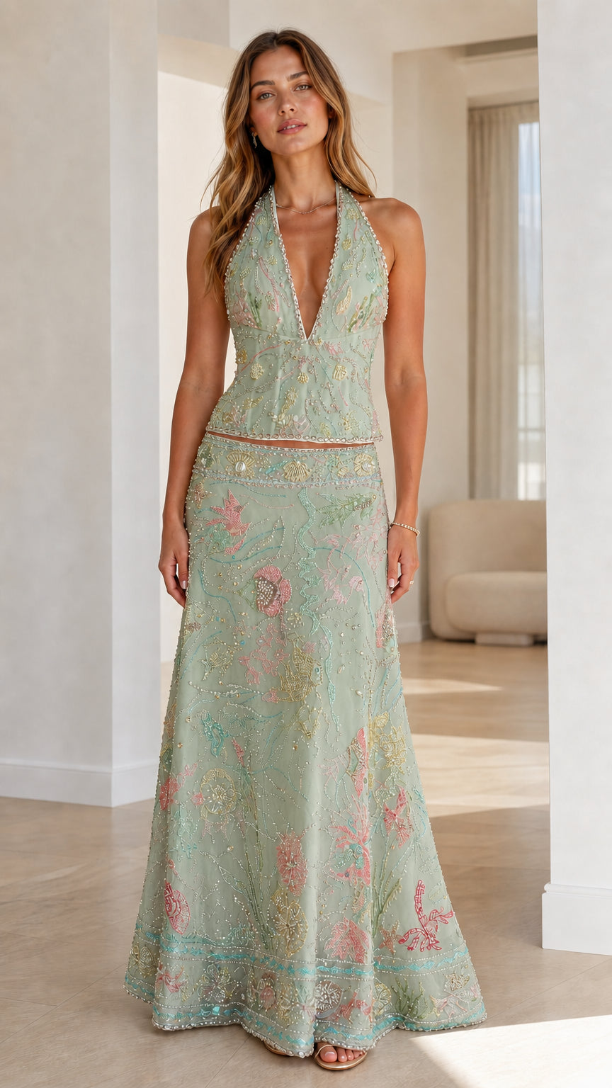 Woman wearing sage green embroidered halter crop top and maxi skirt set