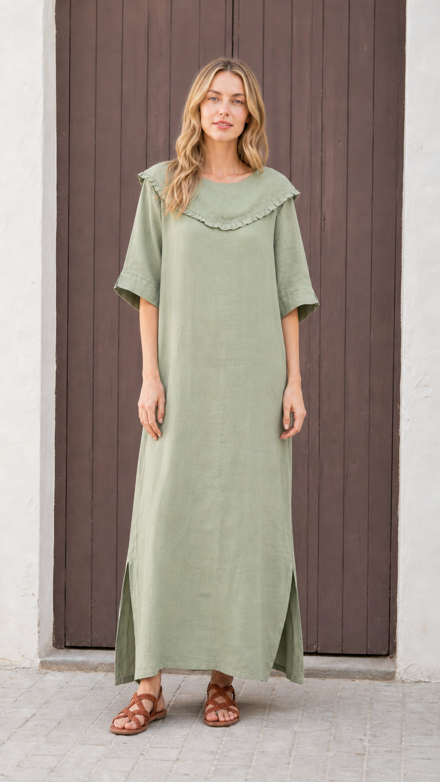 Front view of woman wearing sage green relaxed-fit maxi dress