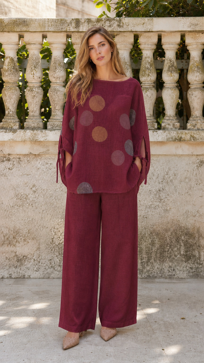 Front view of woman wearing burgundy polka dot two-piece set