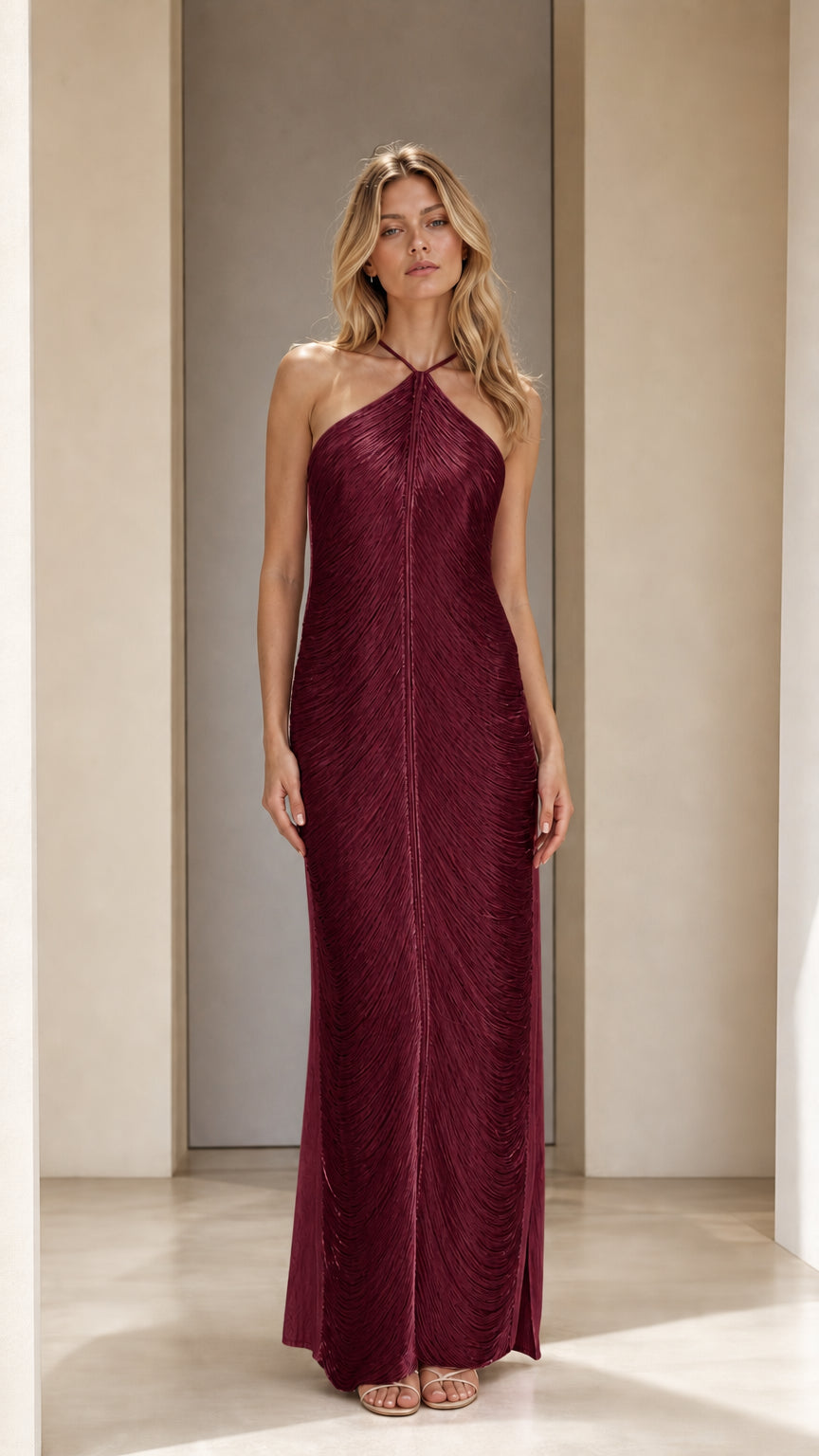 Model wearing burgundy halter neck pleated maxi dress