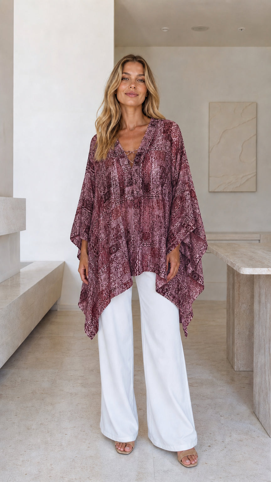 Model wearing burgundy printed boho poncho top