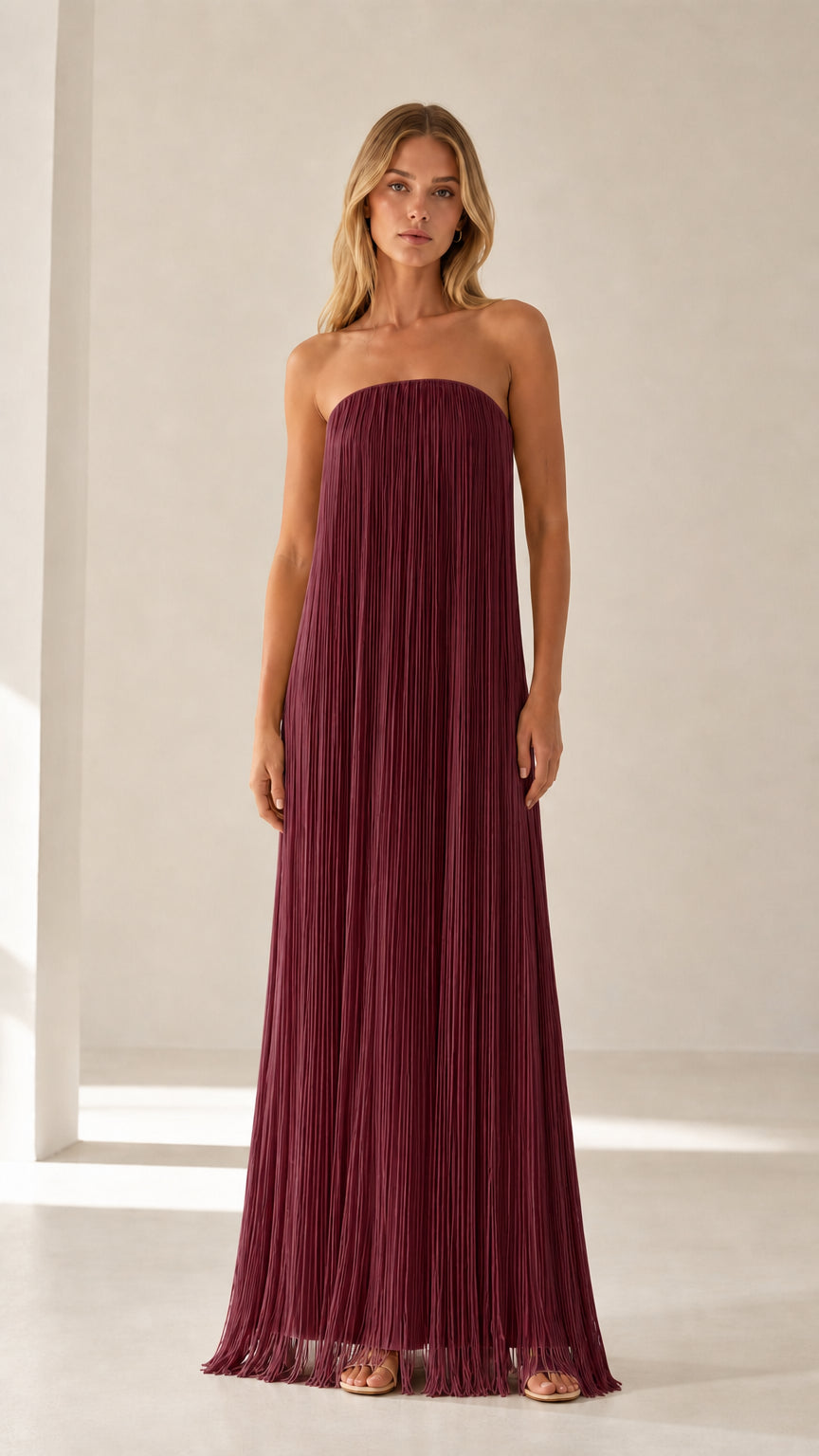 Model wearing burgundy strapless pleated maxi dress