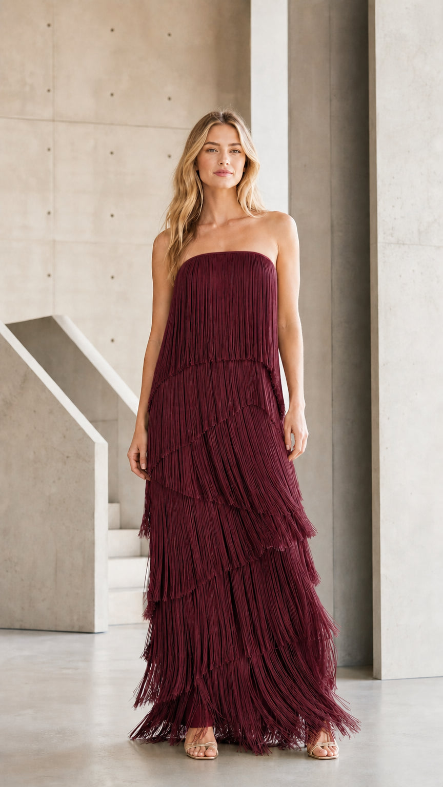 Front view of burgundy tiered fringe strapless maxi dress