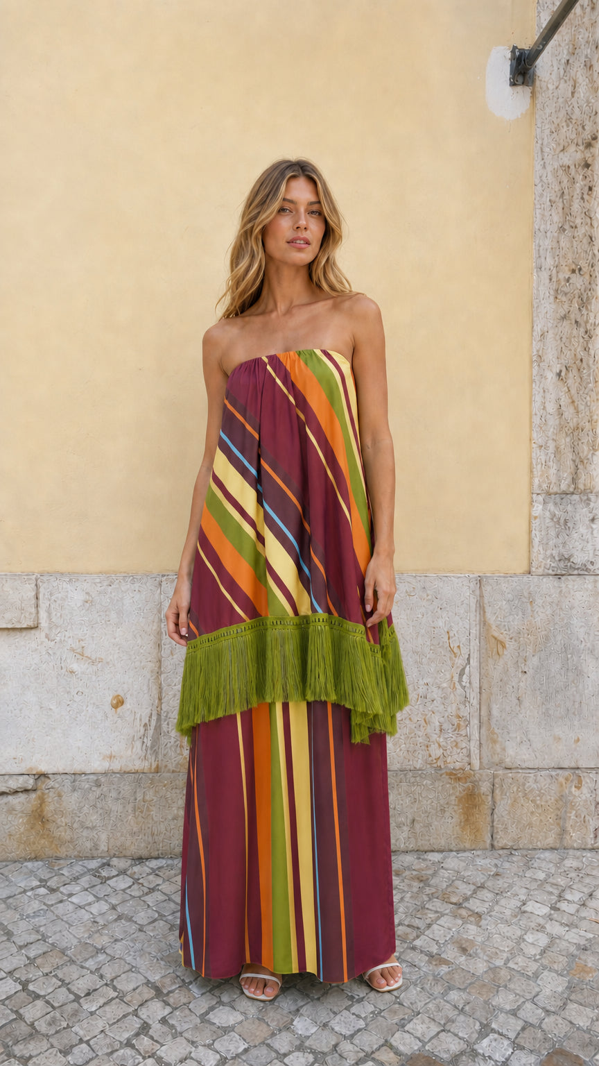 Front view of model wearing Burgundy Multi striped strapless fringe maxi dress