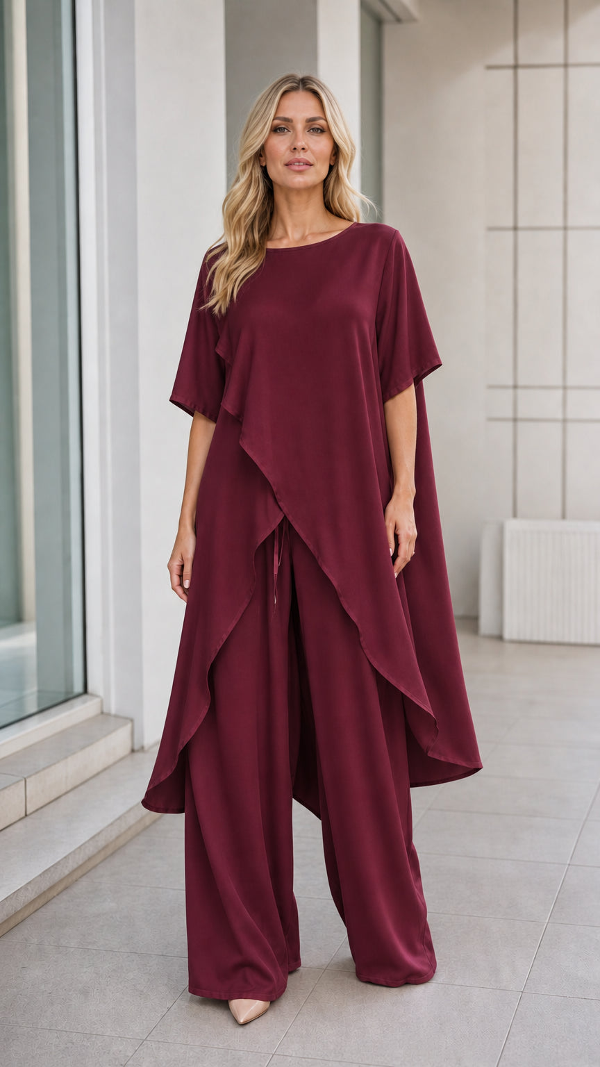 Model wearing burgundy asymmetric tunic and wide-leg pants set