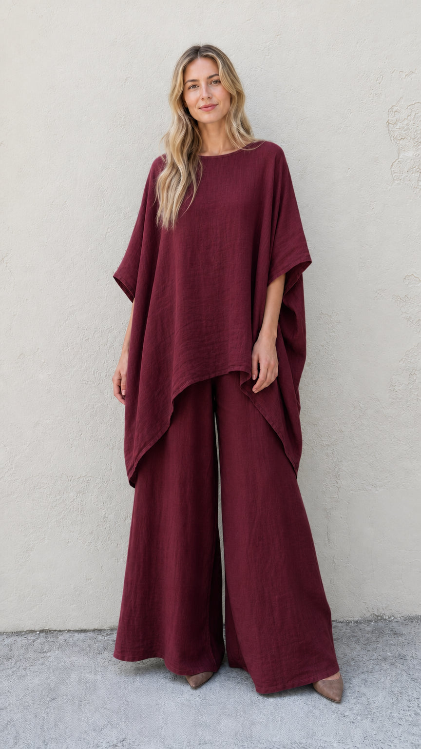 Woman wearing burgundy two-piece poncho and wide leg pants set