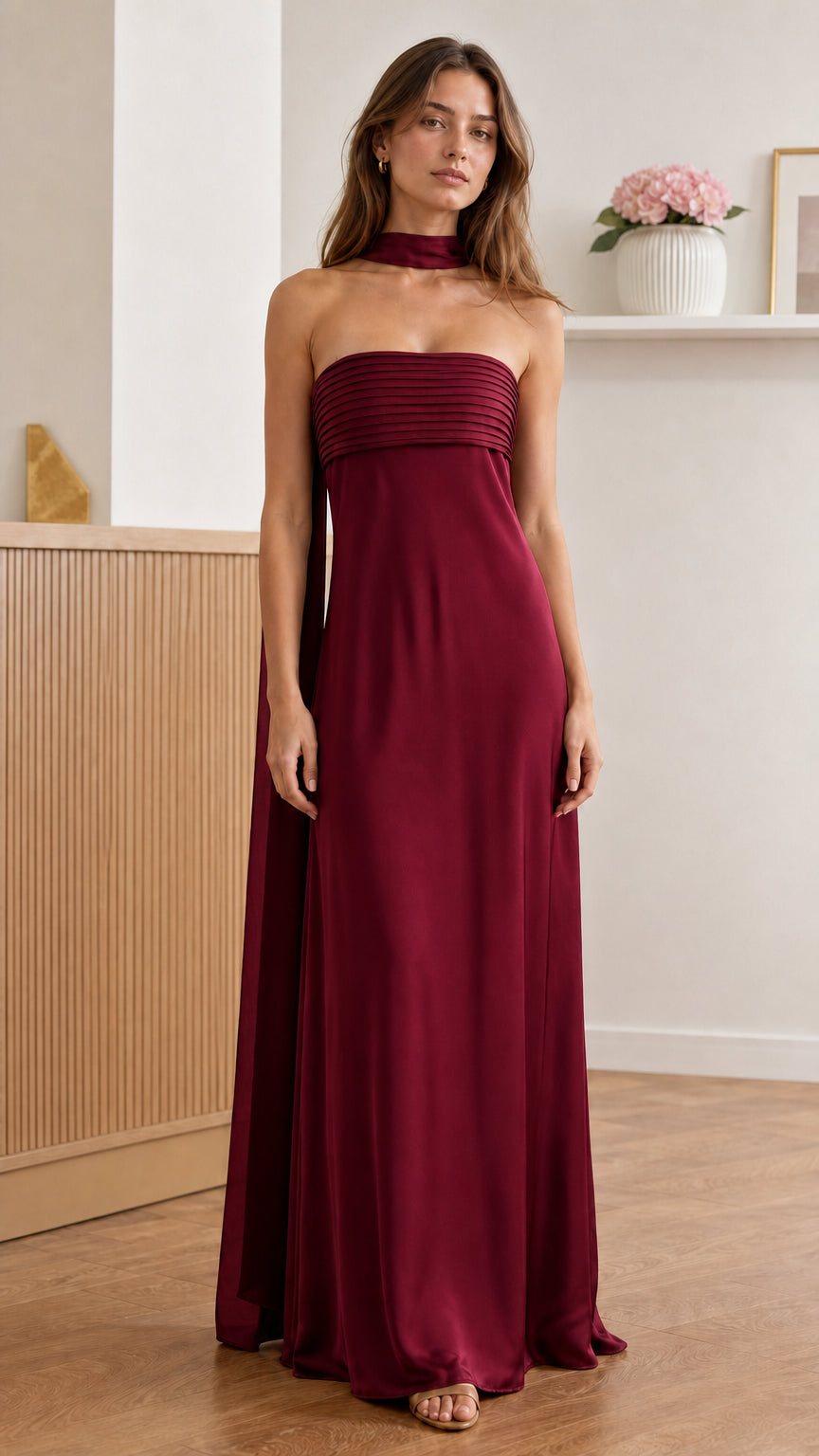 Front view of model wearing burgundy pleated strapless maxi dress