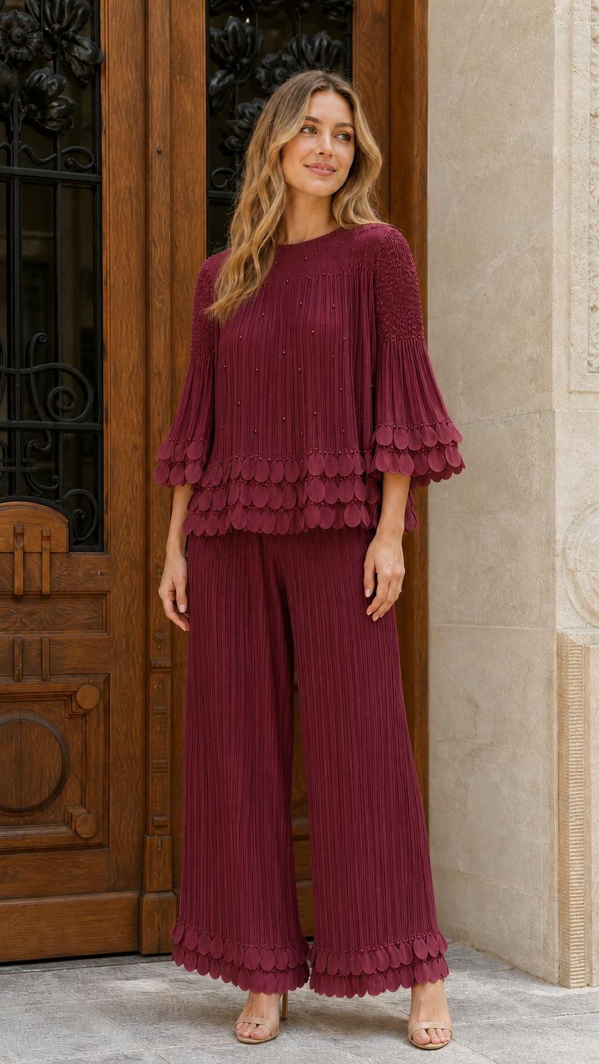 Model wearing burgundy pleated two-piece set