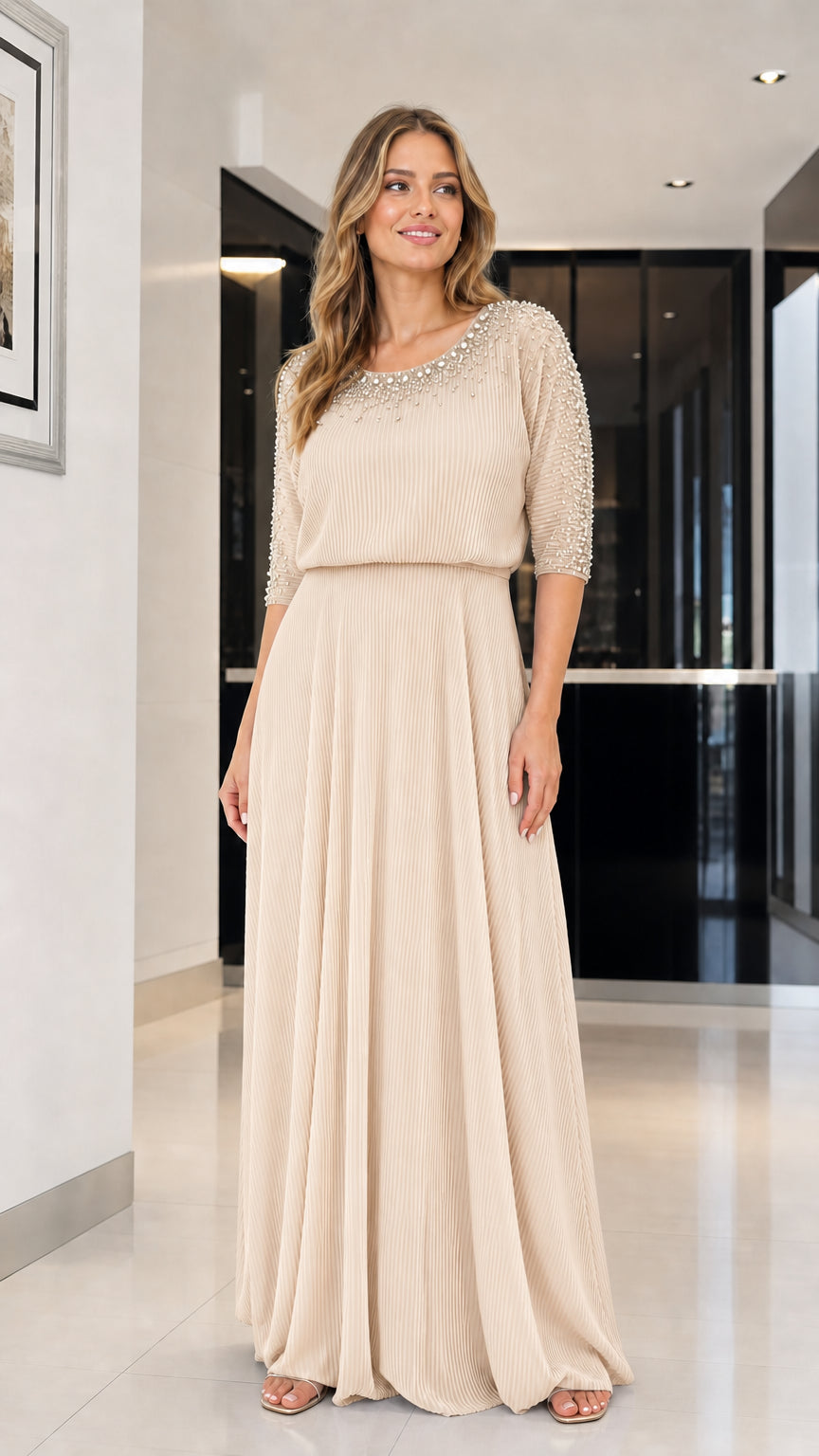 Model wearing champagne beaded pleated maxi dress