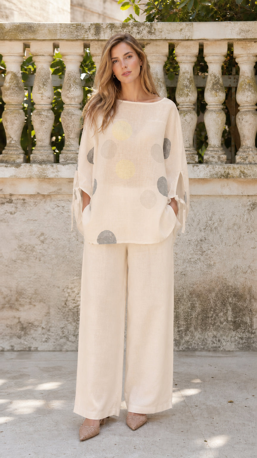 Front view of woman wearing beige polka dot two-piece set