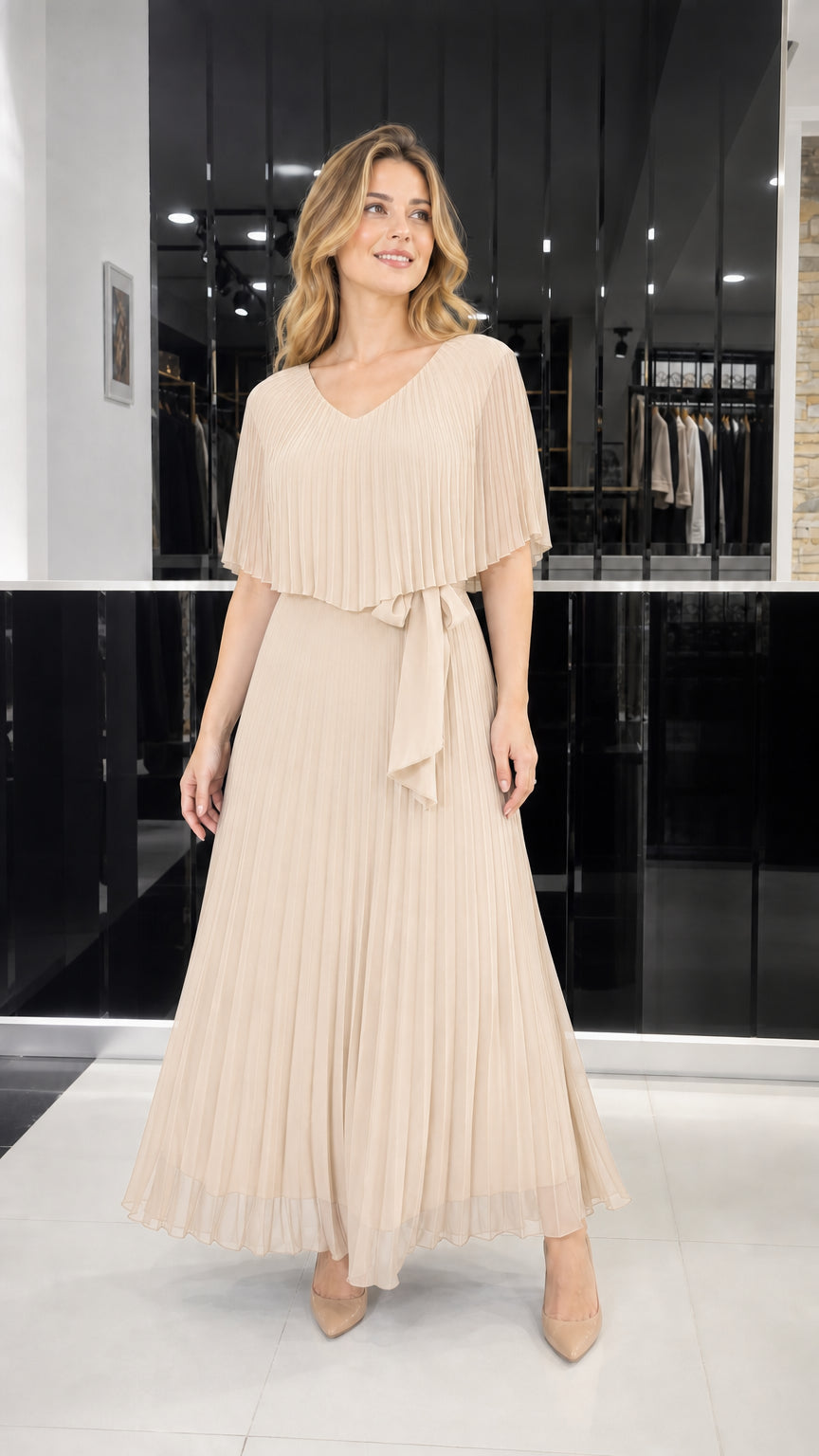 Model wearing champagne pleated cape overlay maxi dress